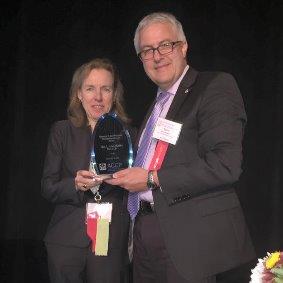 Dr. Lisa von Moltke receives the Nathaniel T. Kwit Memorial Distinguished Service Award from Dr. Meibohm